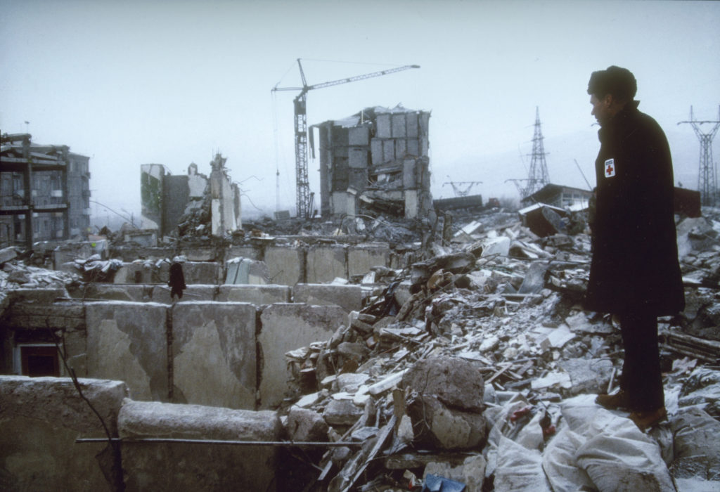 American Red Cross President Dick Schubert surveys the damage following the Spitak earthquake. 