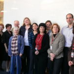 RUTH_SCHLOSS(4th and 5th from Left); Holocaust survivor Ruth Schloss and her husband Ralph Schloss pose with Red Cross Tracing team members (Left to Right); Lisa Ghali, Francoise Max, Jennifer Brown, Nicole Rolf, Anglie Tumghap, Judy Stieglitz, Anette Rosenzweig, Paula Brown, Curtis Ricci, Terry Danzig (photo: Anita Salzberg)