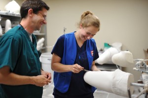 Morgan Oxenrider shapes a cast for a prosthetic leg under the supervision of Todd Slegman. Oxenrider interns for the Red Cross in the prosthetics lab at Walter Reed National Military Medical Facility.