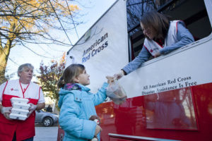 Red Cross worker hands meals out of an emergency response vehicle worst hurricane sandy