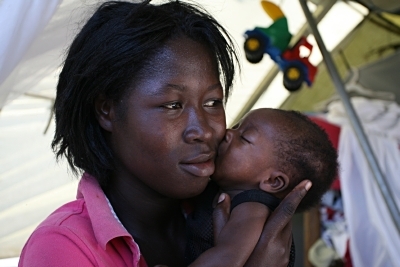 A Haitian mother holds her newborn child close.
