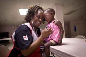 May 2011. Vicksburg, Mississippi. American Red Cross nurse, Regina Hudson with Jermiya Jackson at the Red Cross shelter at the Hawkins United Methodist Church. 