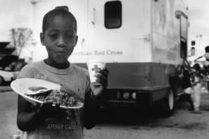  A young boy in Homestead, Florida enjoys a hot meal and a cold drink from a Red Cross Disaster Services truck assisting victims of 1992’s Hurricane Andrew.