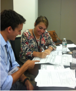 Interns Adam Familiant and Cayla Machleit practice playing the role of Red Cross caseworkers.