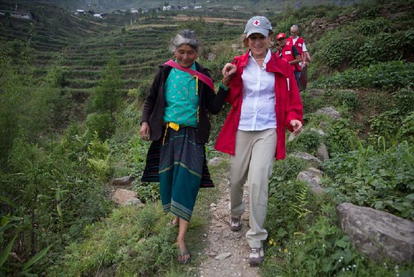 In Rasuwa District, Nepal, May 5, 2015, Gail McGovern meets local woman during a trek along to see destroyed houses along the remote hills near Dunche with Red Cross staff. 