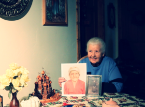 Marta Kruk Lysnewycz in her home with pictures of her, Vassia, and their mother.