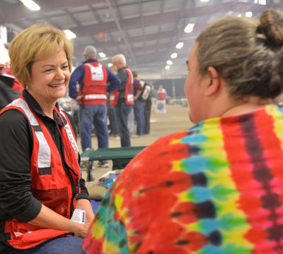 Carolyna, a Red Cross volunteer speaks to a-Michelle, a shelter resident.