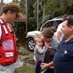 Red Cross volunteer talks with family impacted by Hurricane Matthew