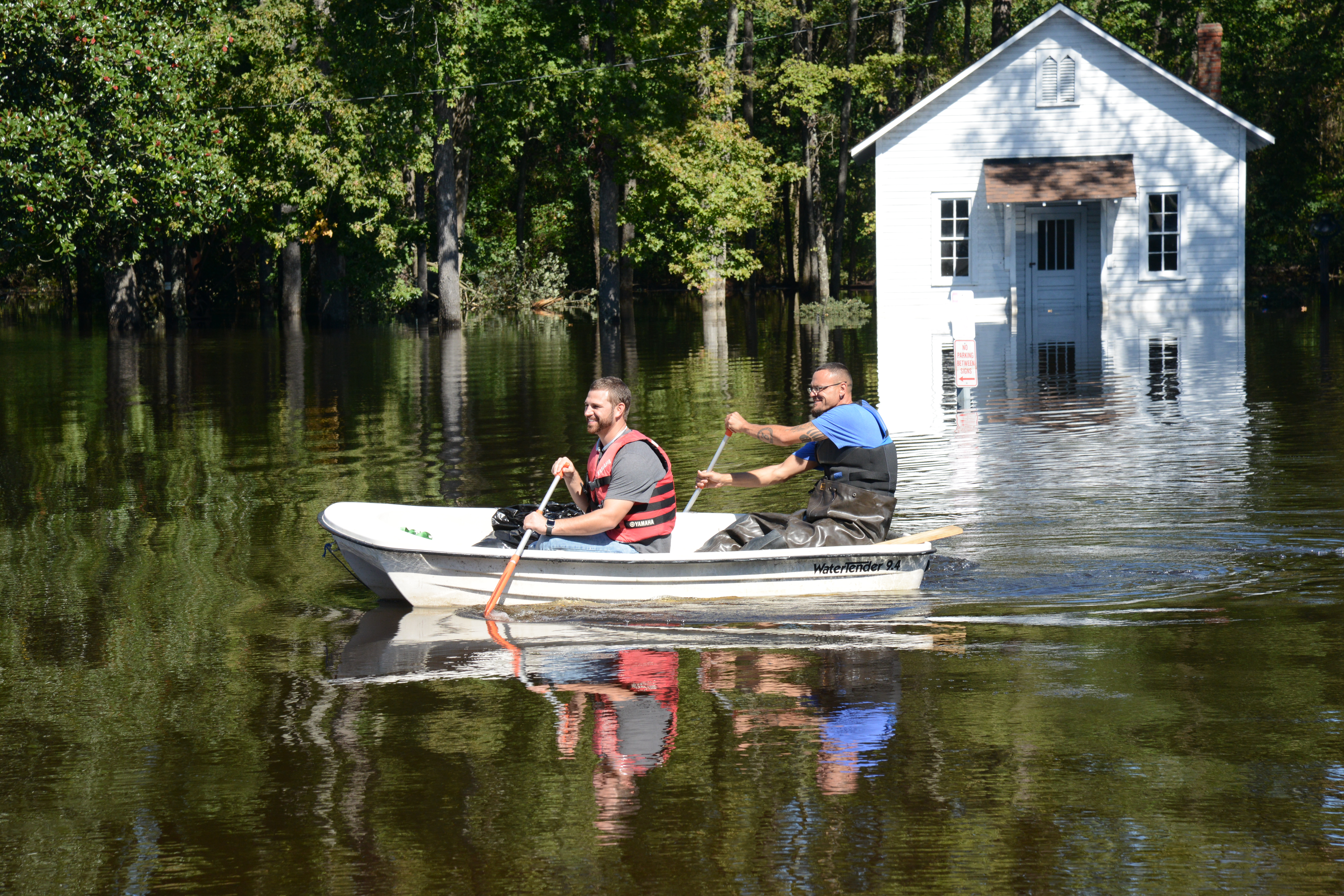 October 11, 2016. Lumberton, North Carolina. Gregory Moad left his house in Lumberton when the waters began to rise, and later realized he’d be unable to return to retrieve clothes and necessities on foot or by car, so he borrowed a boat. His friend Keith Cummings helped row Gregory over to his house to climb in, and get some essentials; and despite the unusual and difficult circumstances, the two were in good spirits as they rowed back to high ground. 