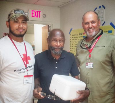 Red Cross volunteers standing with St. Thomas resident