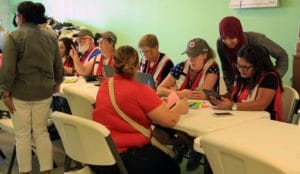 Red Cross workers sit down to talk with clients.