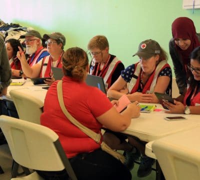 Red Cross workers sit down to talk with clients.