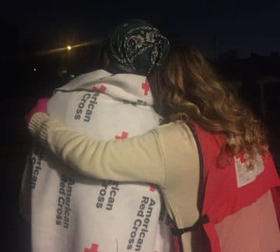 Home fire victim comforted by Red Cross volunteer