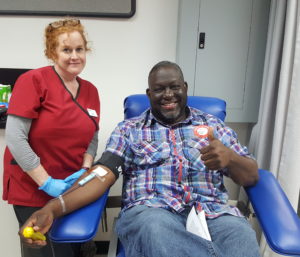 Luci and TJ smiling during blood donation