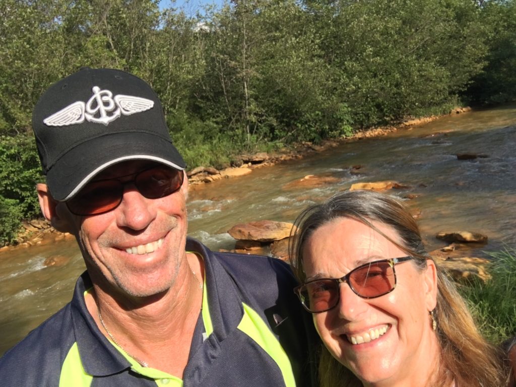 Kathy and George in front of a river 
