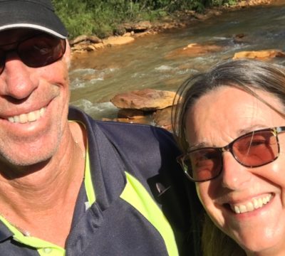 Kathy and George in front of a river