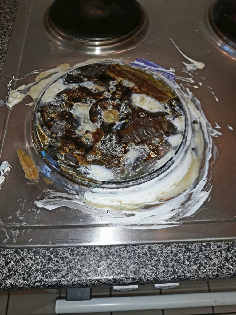 The stovetop with burned plastic on it. 