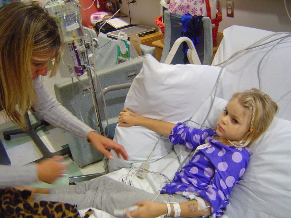 Liviya Anderson in a hospital bed as a young girl.