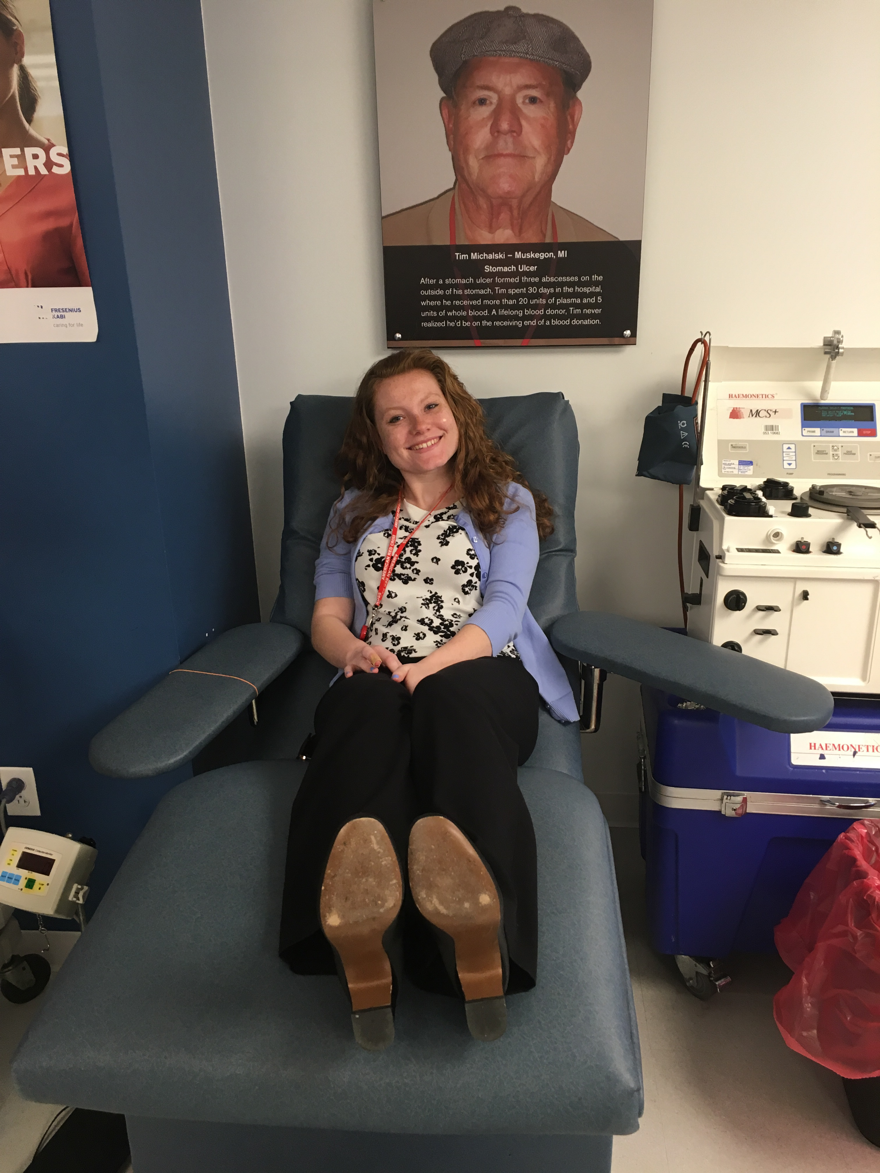 Katie sitting on a chair in the blood center before her blood donation. 