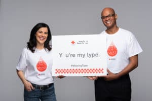 A man and a woman wearing Missing Types blood donation t-shirts.