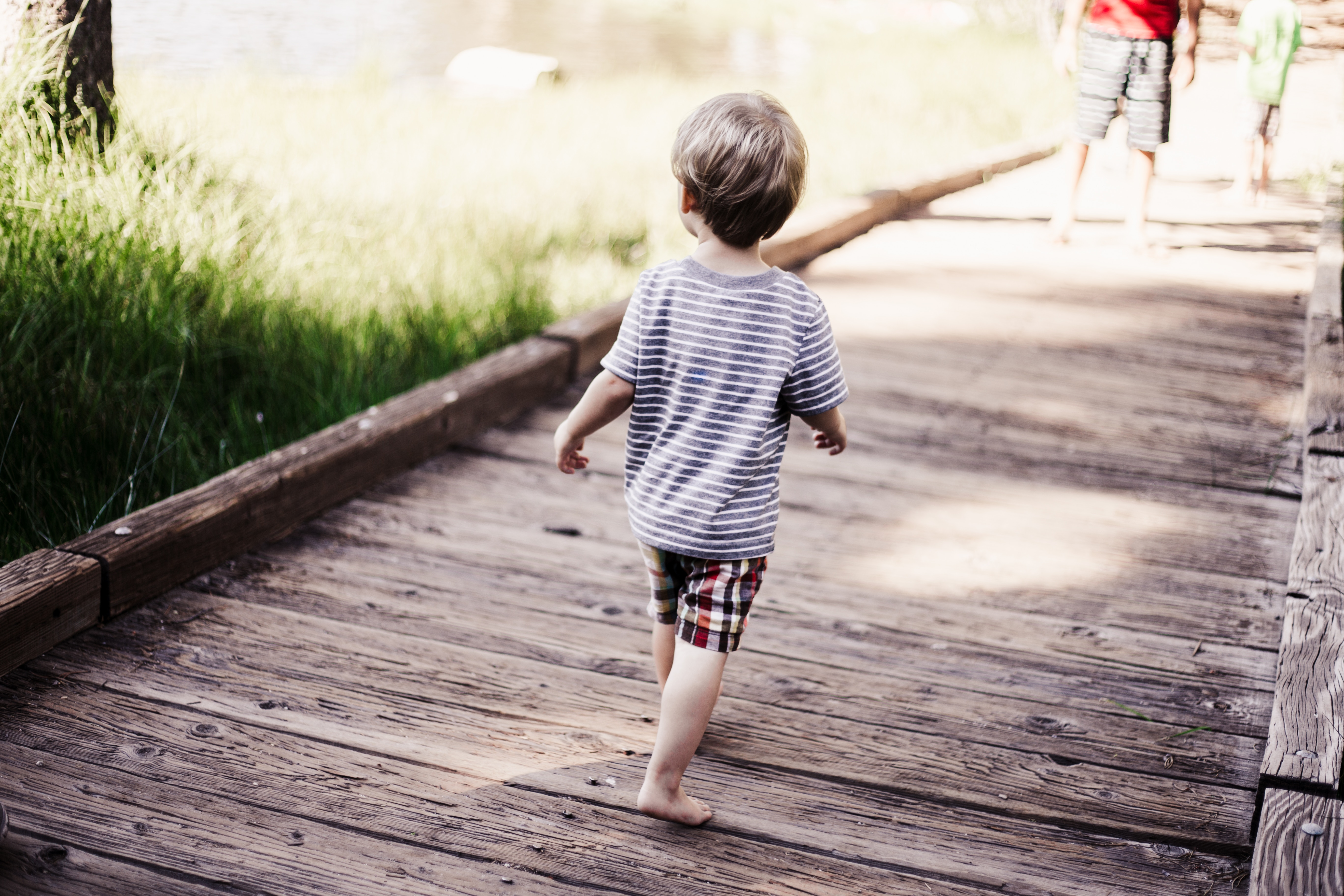 Little boy running on a bridge. 