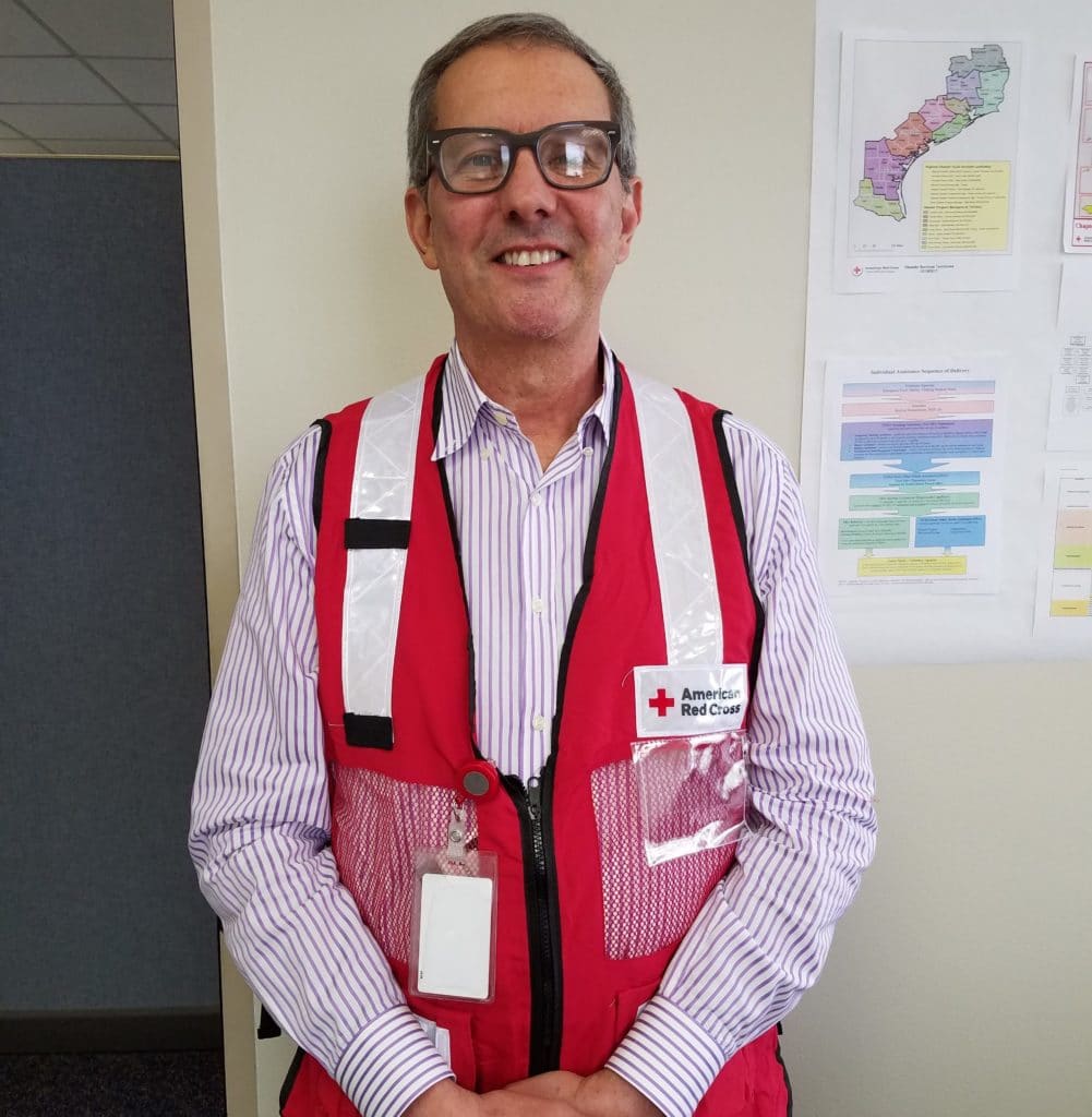 Marco standing in his Red Cross vest.