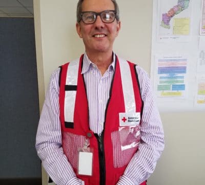 Marco standing in his Red Cross vest.