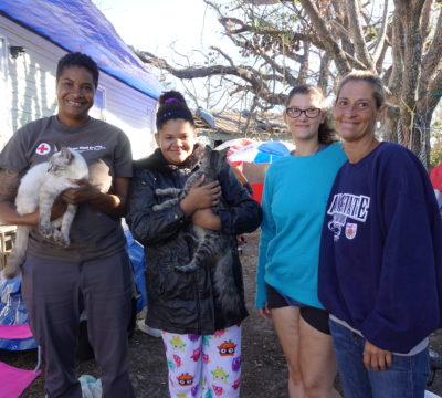 Red Cross volunteer Shanda Scott (left), poses with Jessica Manson (far right) and her children Dominique and Kaitlyn. Jessica and her family are caring for local animals in the aftermath of Hurricane Michael