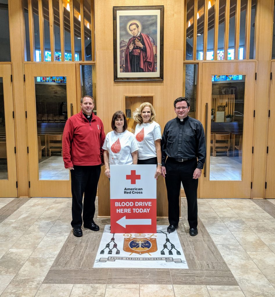 Church leaders standing with Red Cross staff at their blood drive. 
