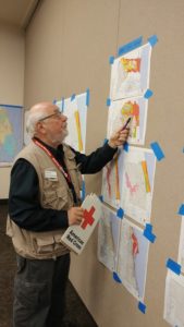 David mapping out districts on the wall during a disaster operation.