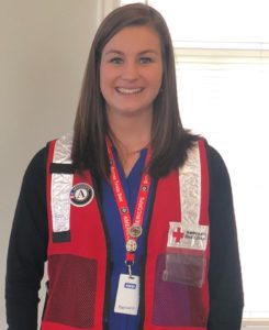 Lauren Snow standing in her Red Cross vest. 