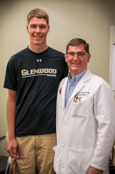 Jacob standing next to his doctor.