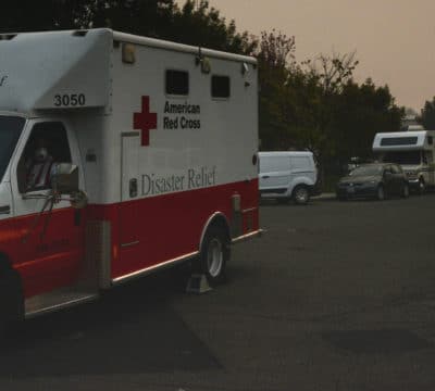 World Central Kitchen Camp Fire Relief Operation, Chico, California. An Emergency Response Vehicle waits to pick up the next meal while the thick smoke envelopes everything and the daytime sun is vanquished. Photo by Daniel Cima/American Red Cross