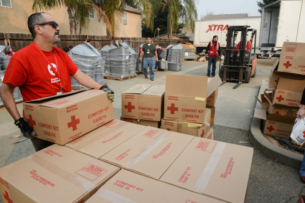 Red Cross volunteers working with partners to get donated goods to people in need.