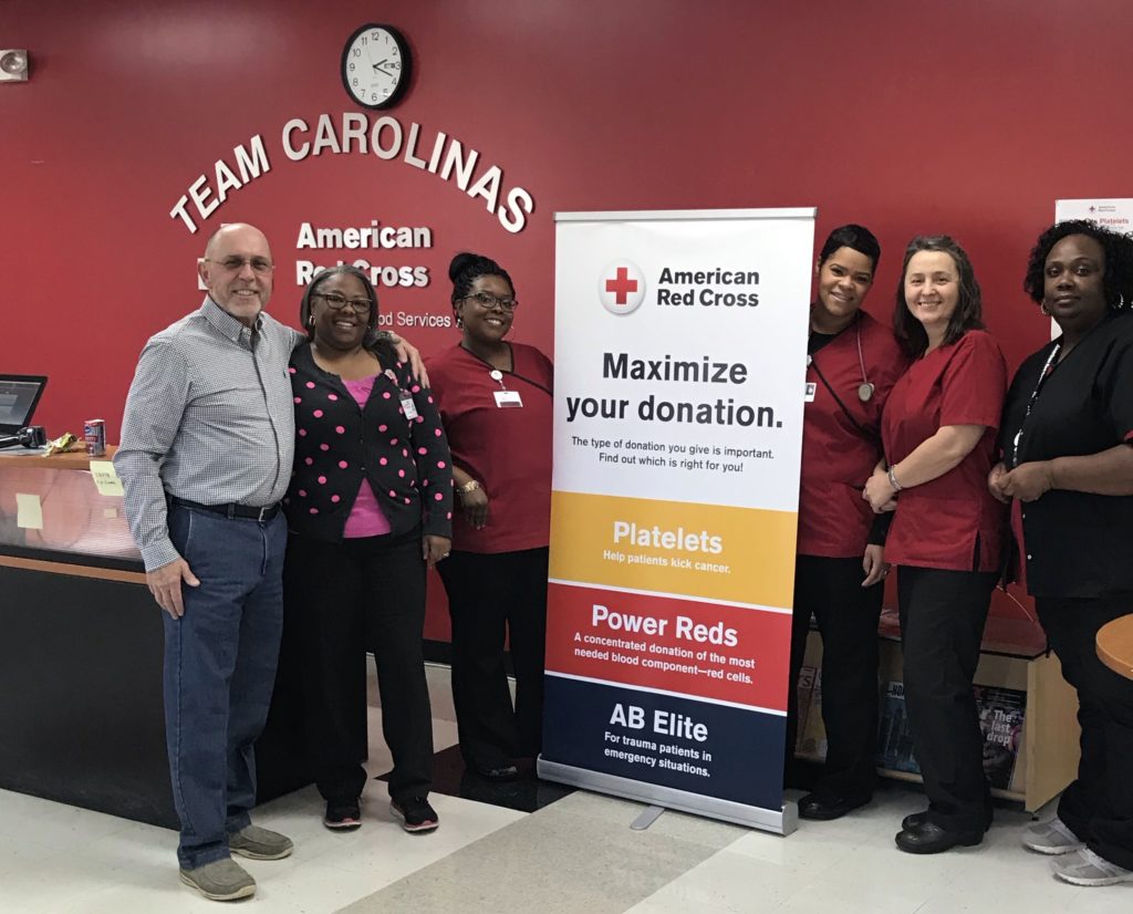 Kirk Davis standing with phlebotomists at a blood center in North Carolina.