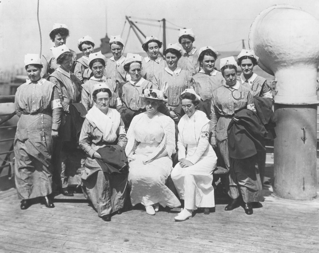 Jane Delano sitting and posing with American Red Cross nurses. 