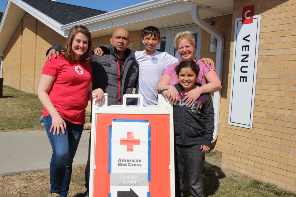 April standing with the Lemus family outside of a Red Cross shelter in Nebraska.