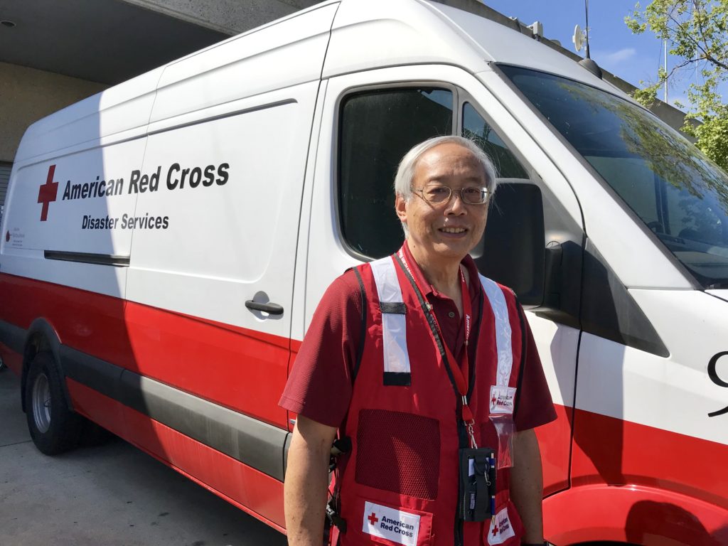 Cliff Hu standing in front of a Red Cross emergency response vehicle.