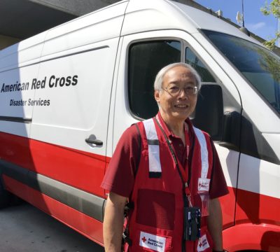 Cliff Hu standing in front of a Red Cross emergency response vehicle.
