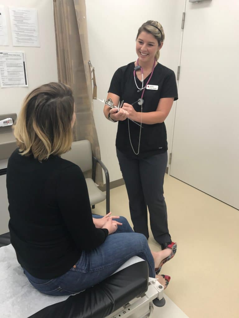Sydney providing care to a patient. 