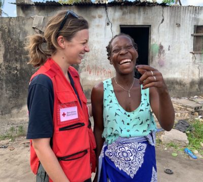 Katie and Gina Tomas Duarte, a resident of Beira, find time to connect and laugh despite the hardship many face in communities across Mozambique.
