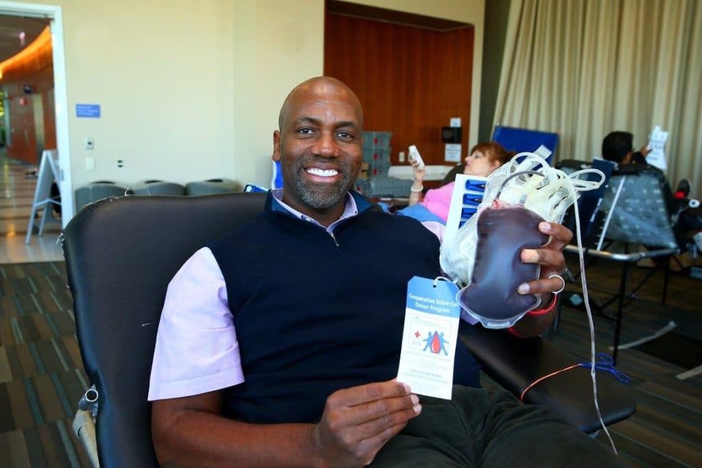 Dr. Mack holding his blood donation. 