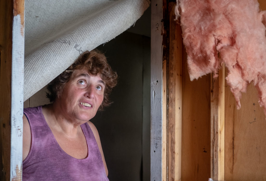 Margaret Phillips stands inside her damaged home after the fire. 