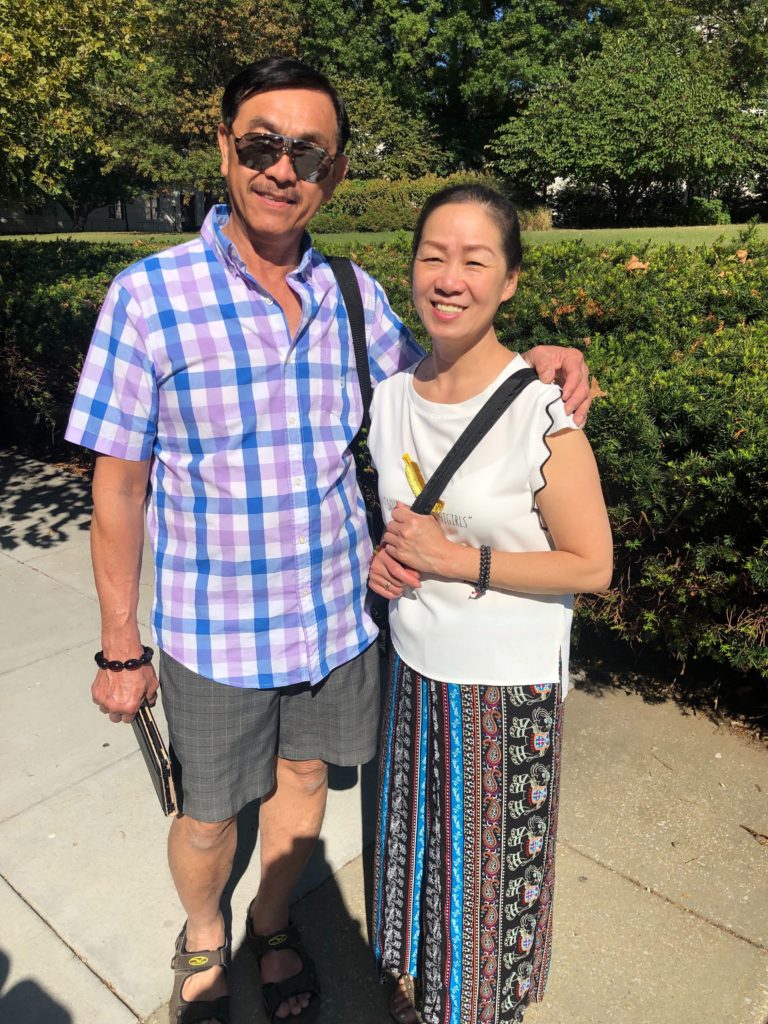 Lisa standing with her husband, Cuong.