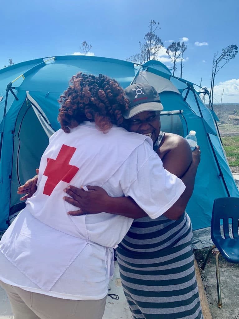 A Bahamas resident hugging an emotional support volunteer. 