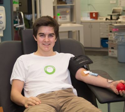 Jacob sitting in a blood donation chair.