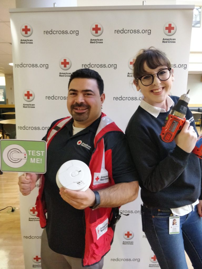 Hanna standing with a fellow Red Crosser during a Sound the Alarm event.