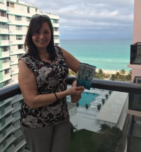 Manolita standing on a balcony with her Super Bowl tickets.