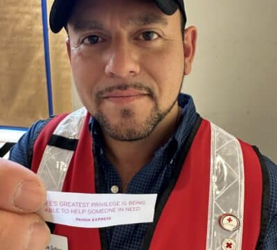 Red Crosser holding fortune from Panda Express cookie