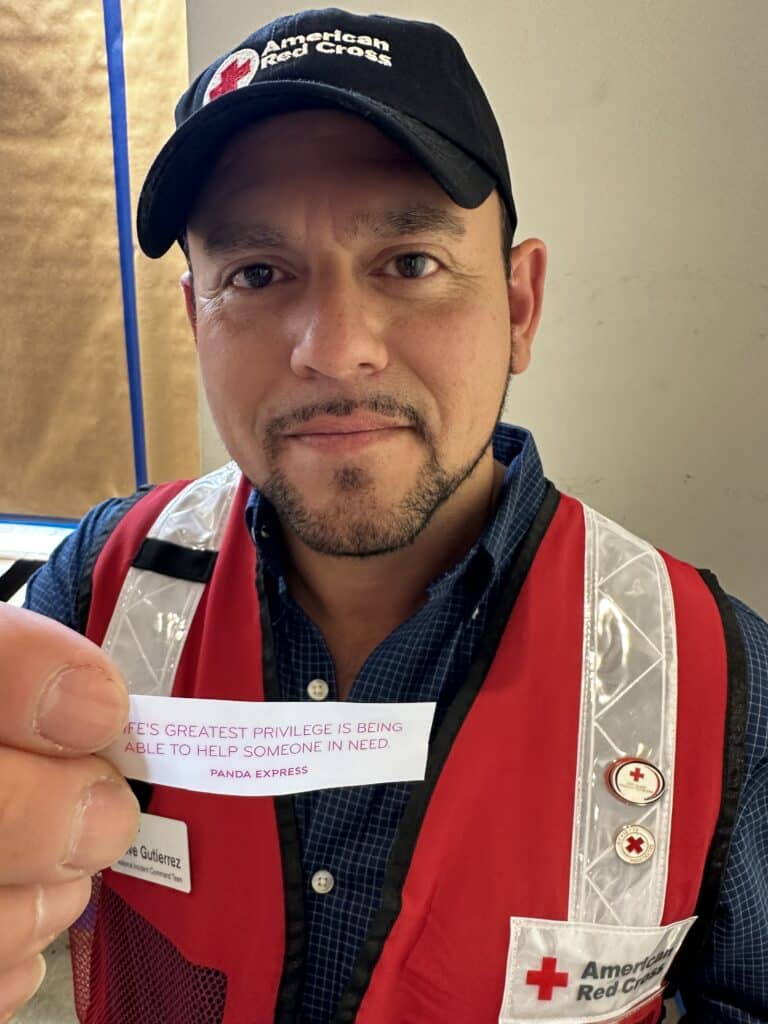Red Crosser holding fortune from Panda Express cookie
